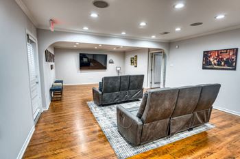 Community lounge with leather seating and entertainment center